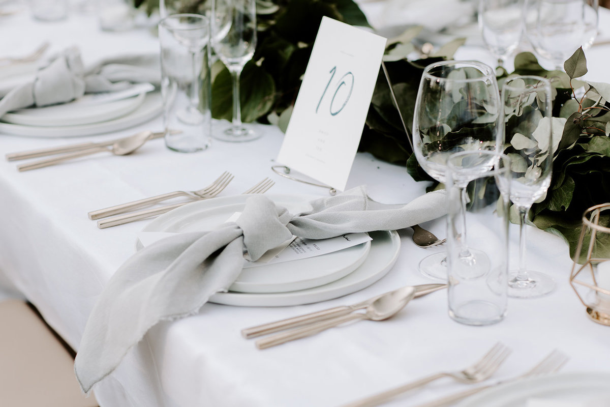 Tahoe Wedding Planners table with La Tavola Tuscany White linen and garland at venue Mitchell's Mountain Meadows Truckee, Joy of Life Events image by The Shepard Photography