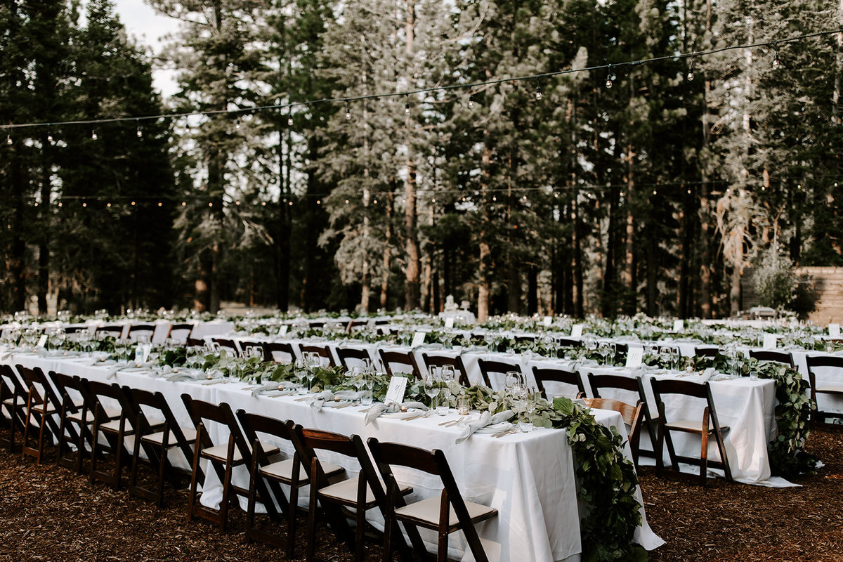 Tahoe Wedding Planners tables with La Tavola Tuscany White linen and garland at venue Mitchell's Mountain Meadows Truckee, Joy of Life Events image by The Shepard Photography