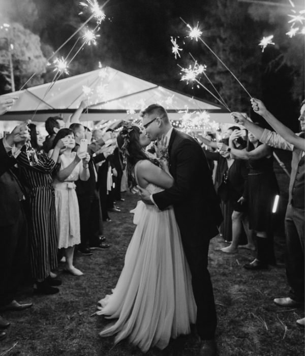 Joyful Lake Tahoe Wedding Planners couple kissing under sparklers, fall wedding at venue The Chalet View Lodge, Graeagle near Truckee, Joy of Life Events home page image by Nicole Leever Photography