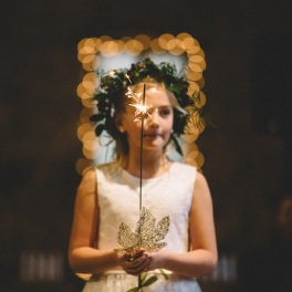 Tahoe Wedding Planners flower girl holding sparkler and wearing crown at venue Miners Foundry Cultural Center​ Nevada City, ​Joy of Life Events image by Myrtle & Marjoram Photography